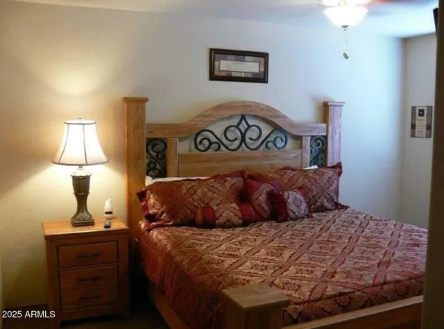 a bedroom with a bed and a lamp