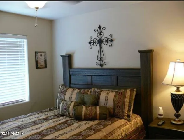 a bed sitting in a bedroom next to a lamp next to a lamp