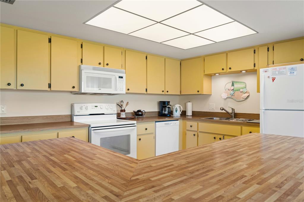 2 Pirates Lane, Unit 23B Punta Gorda, FL 33955 - Photo 32 of 70 a kitchen with a refrigerator sink and cabinets