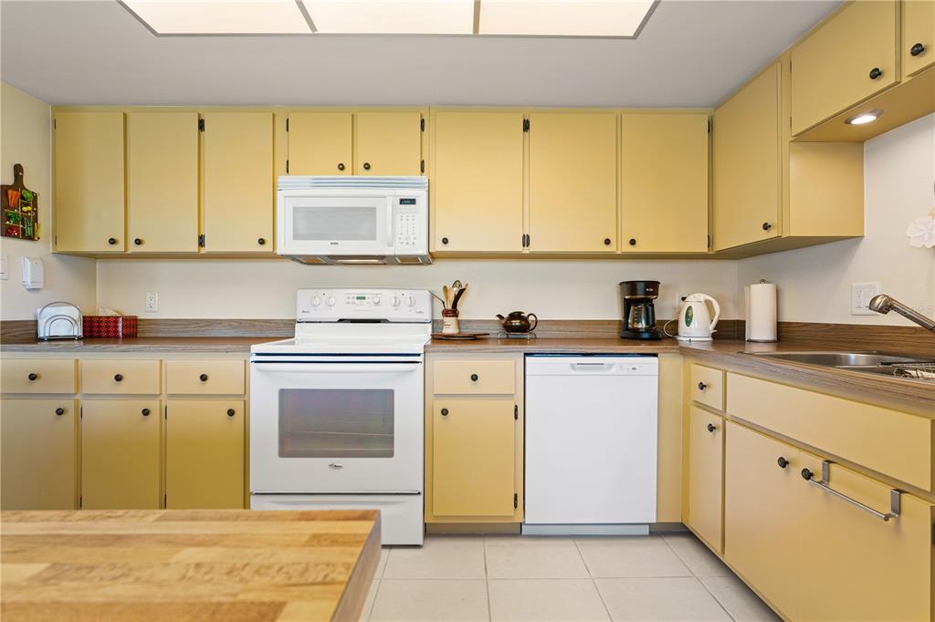 2 Pirates Lane, Unit 23B Punta Gorda, FL 33955 - Photo 33 of 70 a kitchen with a sink cabinets and wooden floor