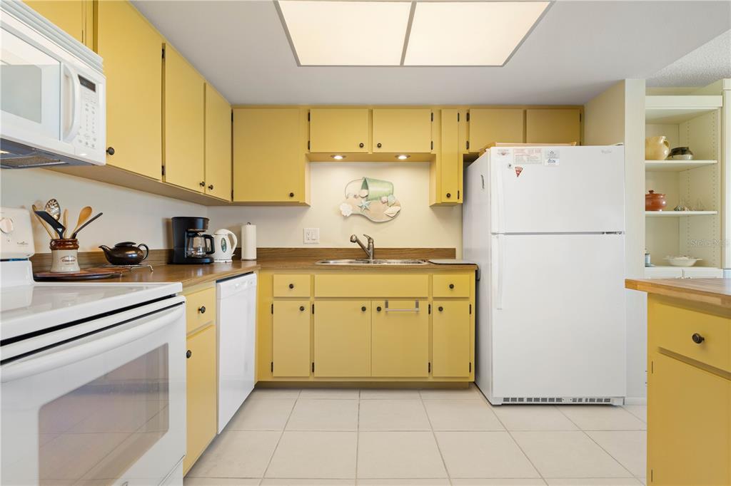 2 Pirates Lane, Unit 23B Punta Gorda, FL 33955 - Photo 34 of 70 a kitchen with a refrigerator a sink and cabinets
