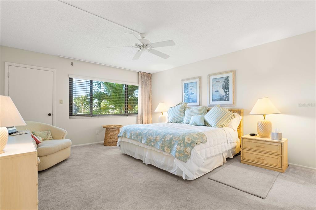 2 Pirates Lane, Unit 23B Punta Gorda, FL 33955 - Photo 38 of 70 a spacious bedroom with a bed and a couch