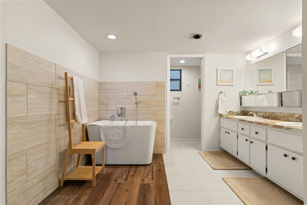2 Pirates Lane, Unit 23B Punta Gorda, FL 33955 - Photo 41 of 70 a spacious bathroom with a double vanity sink a mirror and a bathtub