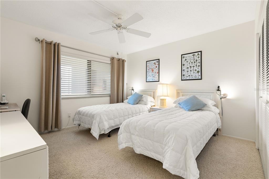 2 Pirates Lane, Unit 23B Punta Gorda, FL 33955 - Photo 48 of 70 a bedroom with two beds and a chandelier