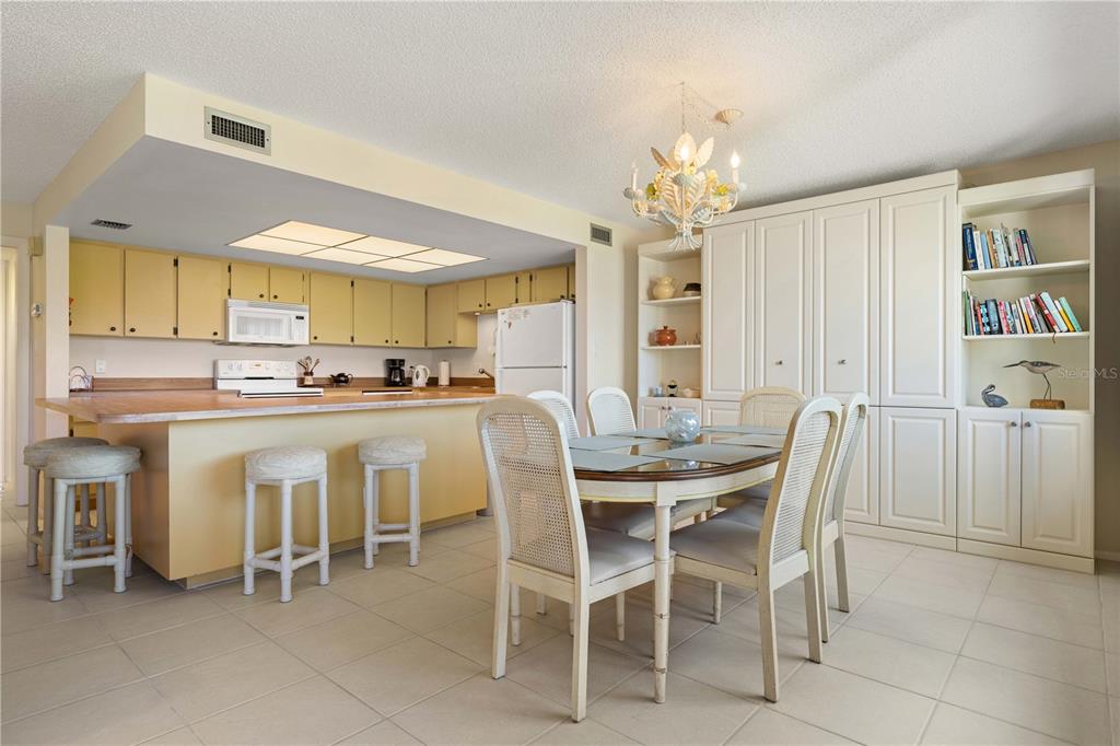 2 Pirates Lane, Unit 23B Punta Gorda, FL 33955 - Photo 7 of 70 a dining room with furniture a chandelier and kitchen view