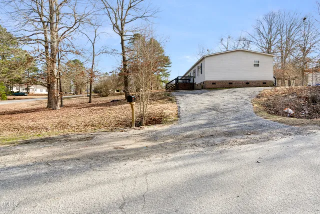 a view of a house with a yard covered in snow