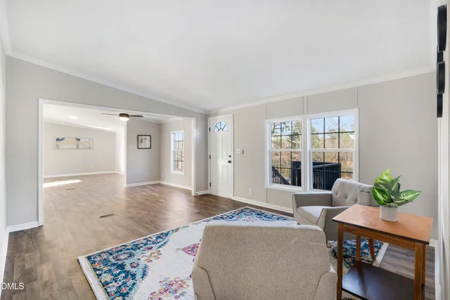 a living room with furniture and wooden floor
