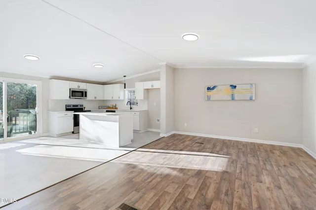 a view of kitchen with sink and refrigerator