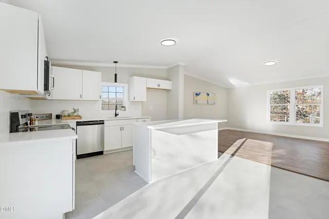 a kitchen with white cabinets and white appliances