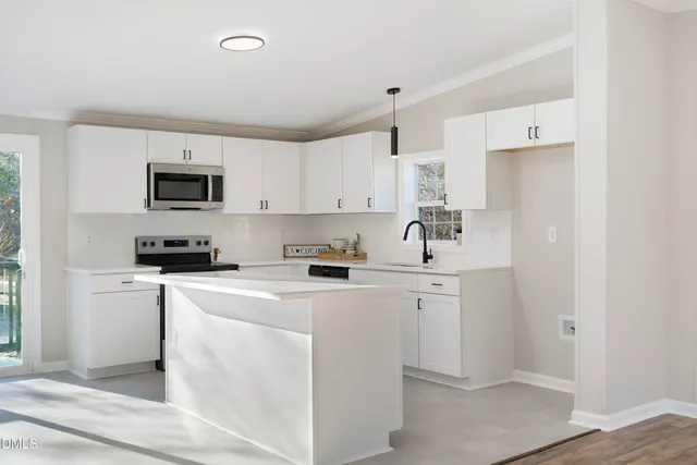 a kitchen with cabinets stainless steel appliances and a counter space