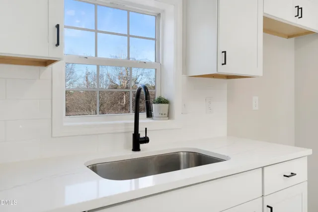 a kitchen with a sink and cabinet