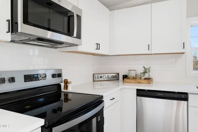 a kitchen with stainless steel appliances a sink stove and cabinets