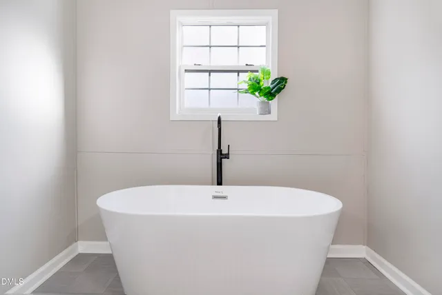 a white bath tub sitting in a bathroom