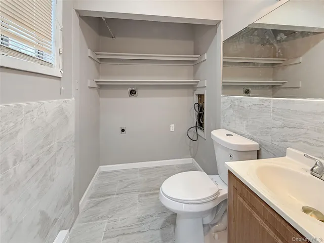 a white toilet sitting next to a bathroom sink