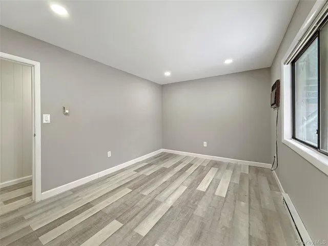a view of room with window and hardwood floor