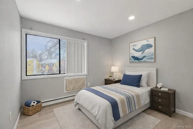 a bedroom with a bed and painting on the wall