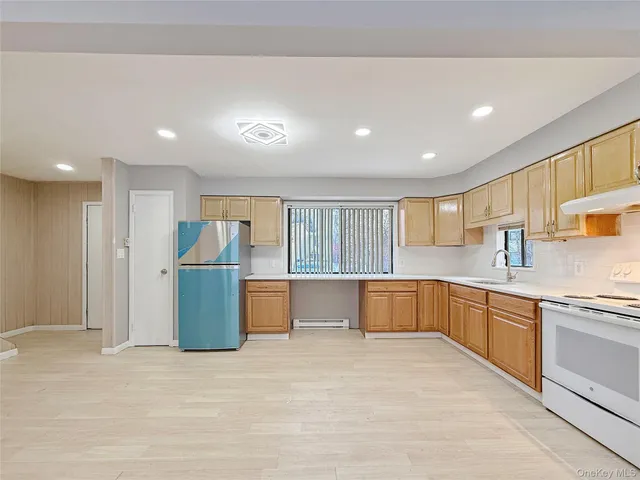 a large white kitchen with a large window