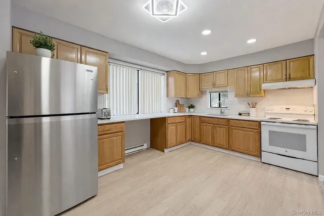 a kitchen with stainless steel appliances granite countertop a refrigerator sink a stove a microwave and island