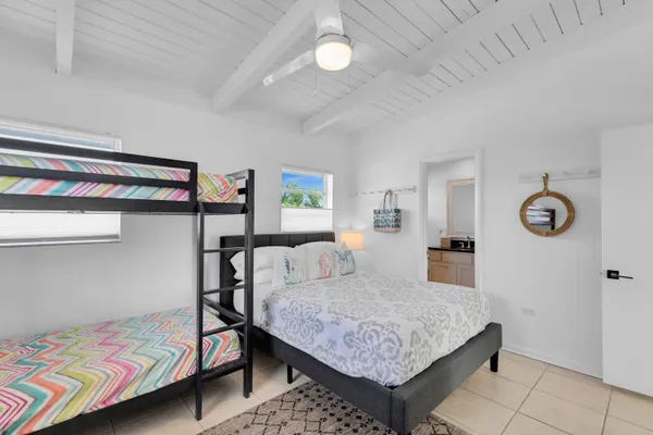 a bedroom with a bed and paintings on the wall