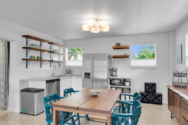 a kitchen with a table and chairs in it