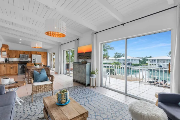 a living room with furniture and a floor to ceiling window