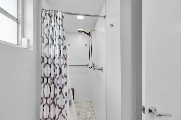a bathroom with a shower and a glass door