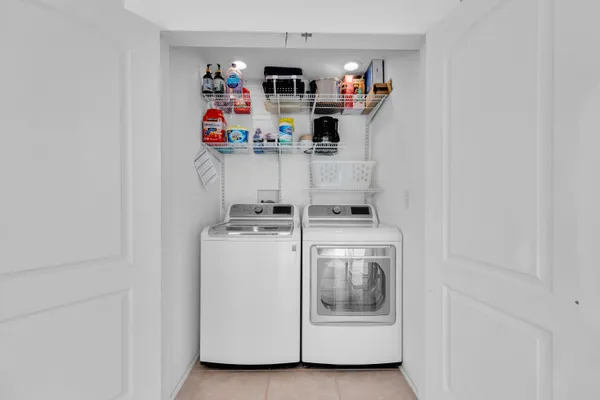 a view of storage and utility room with washer and dryer