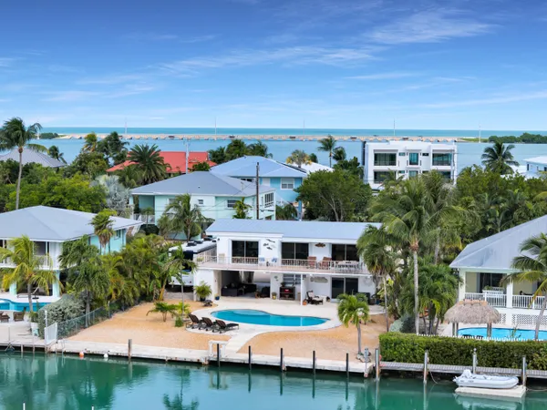 an aerial view of a house with swimming pool garden view and a patio