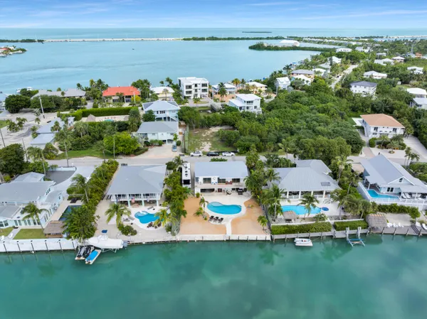 an aerial view of a city with lots of residential buildings lake and ocean view