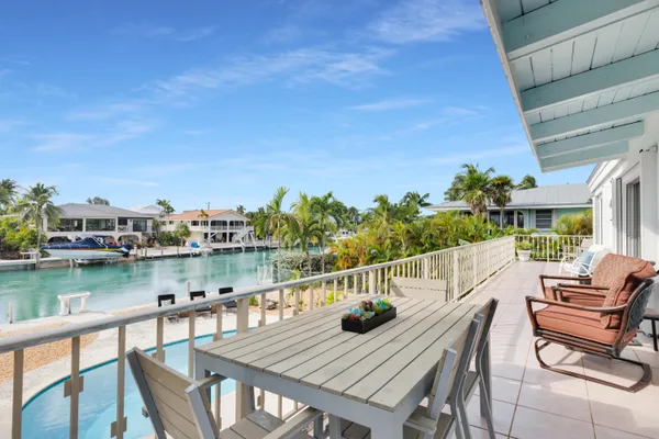a view of a balcony with two chairs and a table