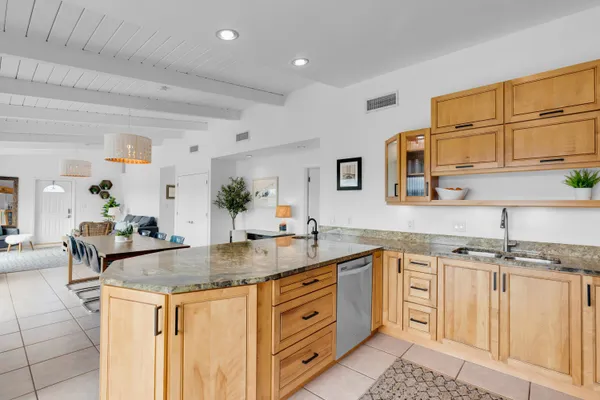 a kitchen with granite countertop a sink and cabinets