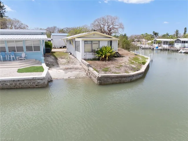 a view of a house with pool and sitting area
