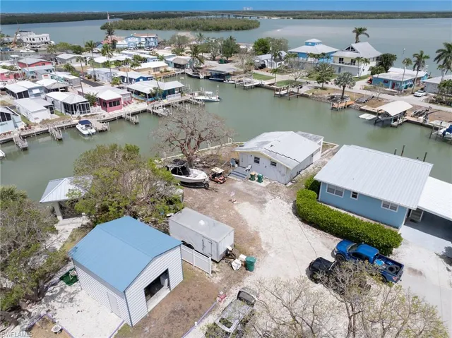 an aerial view of a houses with outdoor space and lake view