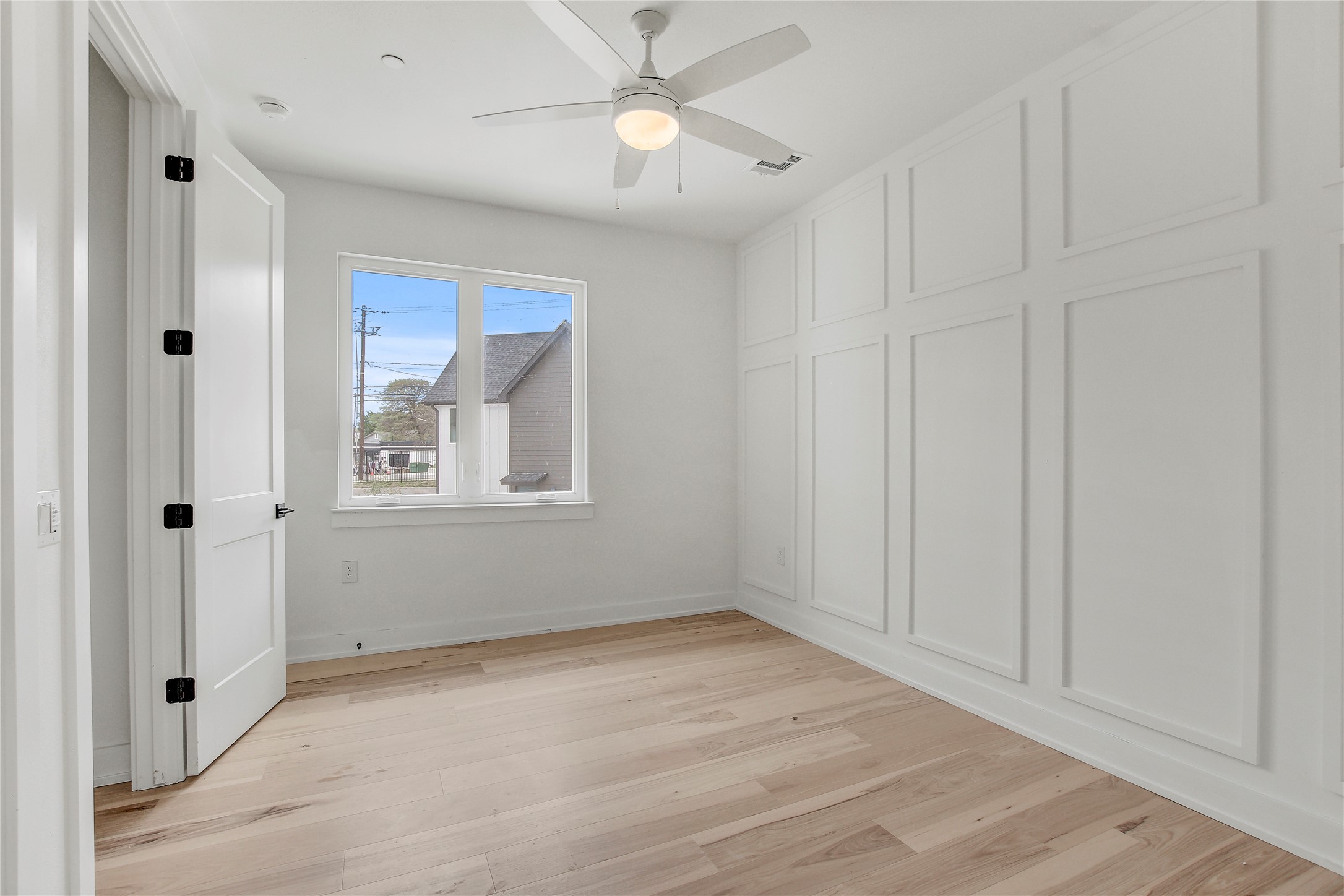 4127 East 12th Street, Unit 2 Austin, TX 78721 - Photo 24 of 28 Unfurnished bedroom with light wood finished floors, baseboards, and ceiling fan