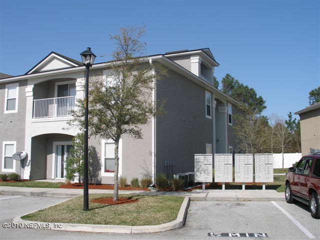 7920 Merrill Road, Unit 910 Jacksonville, FL 32277 - Photo 1 of 1 a front view of a house with a yard