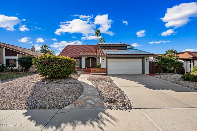 a front view of a house with a yard and a garage