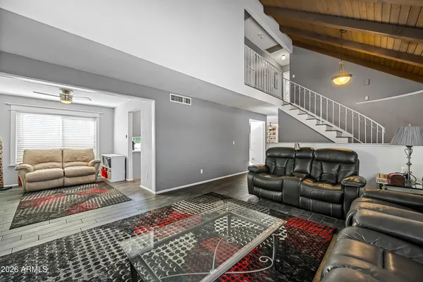 a very nice looking living room with a large window and stainless steel appliances
