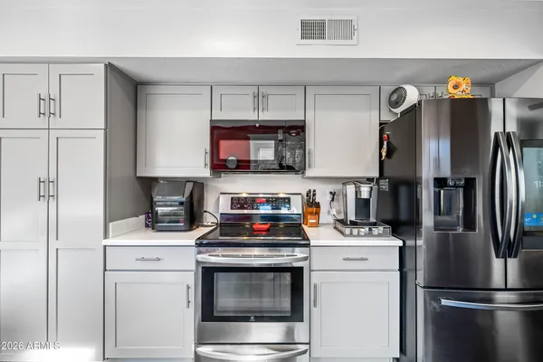 a room with pool table and large windows