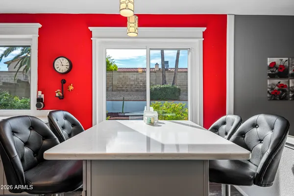 a dining room with a wooden table and chairs