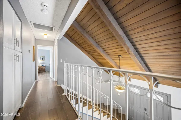 a view of hallway with stairs and wooden floor