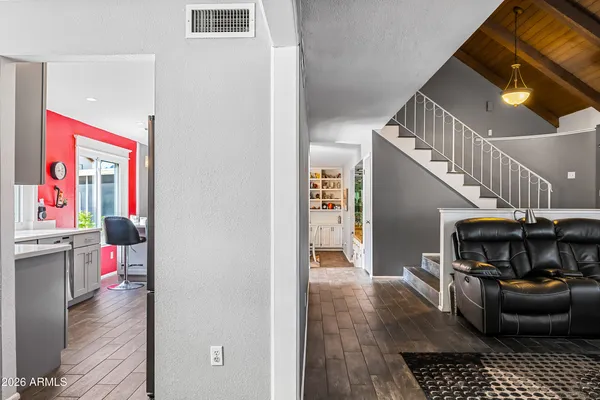 a living room with furniture a rug and a flat screen tv