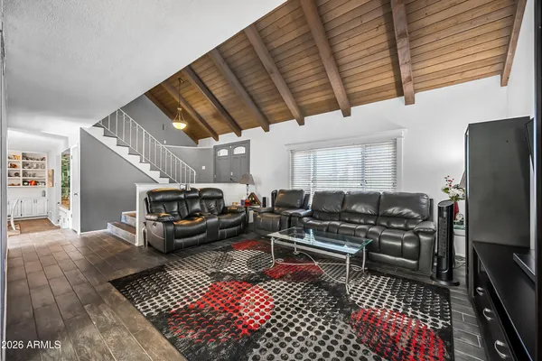 a kitchen with a refrigerator a stove top oven a sink dishwasher and white cabinets with wooden floor