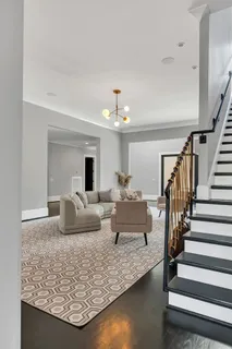 a living room with furniture and a chandelier