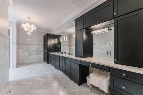 a bathroom with a sink a large mirror and a shower