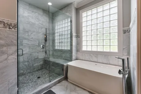 a bathroom with a bathtub and shower