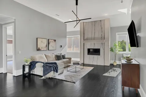a living room with furniture fireplace and a flat screen tv