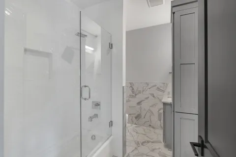 a bathroom with a bathtub and shower