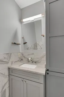 a bathroom with a sink and a mirror