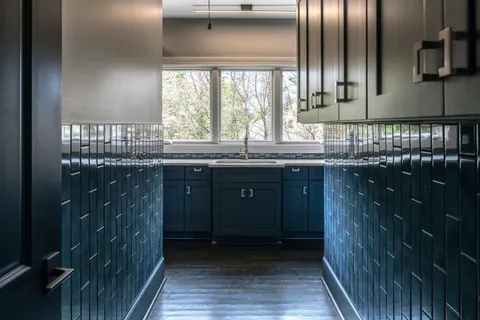 a kitchen with granite countertop a sink and cabinets