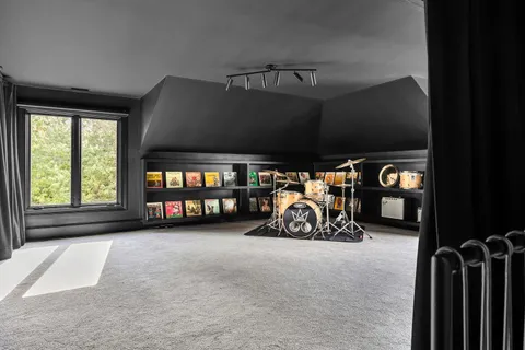 a garage with a bed and a large window